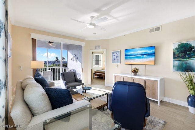 living room with crown molding, light hardwood / wood-style flooring, and ceiling fan