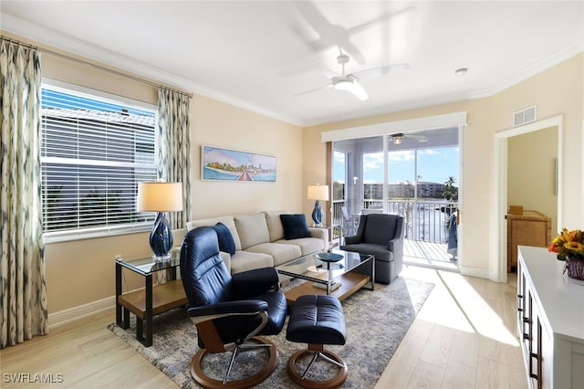 living room with ceiling fan, ornamental molding, and light hardwood / wood-style flooring