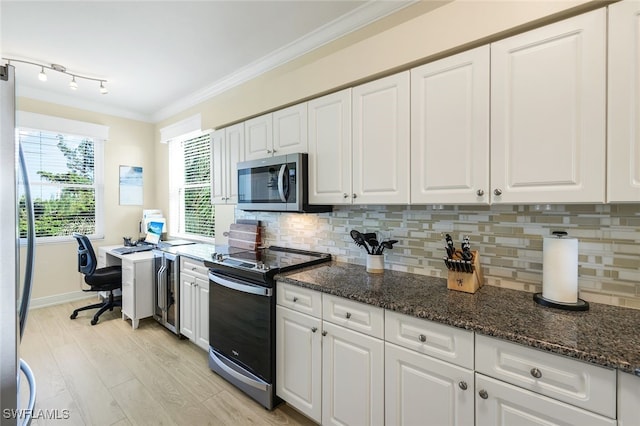 kitchen with white cabinetry, dark stone counters, and appliances with stainless steel finishes