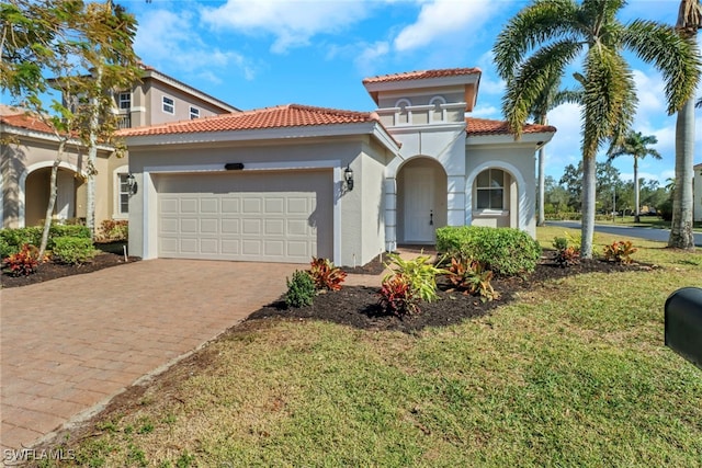 mediterranean / spanish-style home featuring a garage and a front lawn