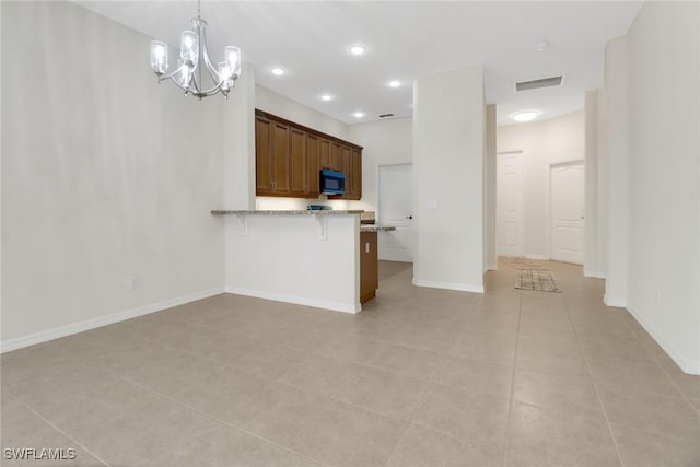 unfurnished living room featuring light tile patterned floors and a notable chandelier