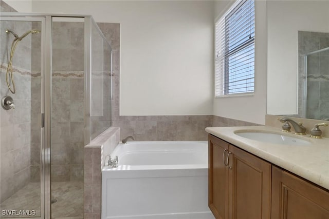 bathroom with vanity and separate shower and tub