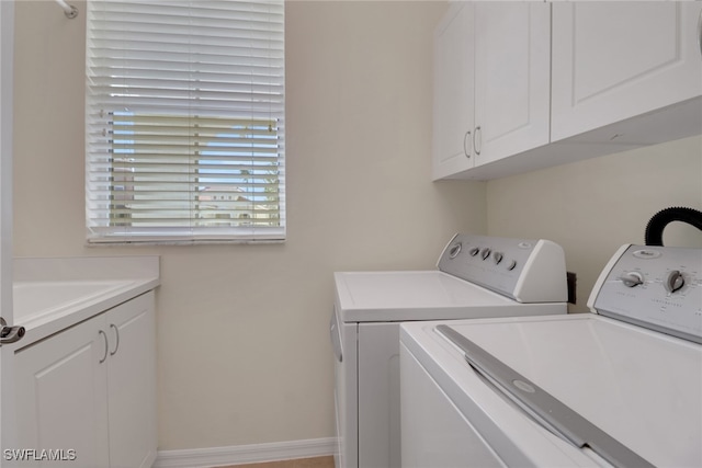 laundry room with cabinets and washing machine and dryer