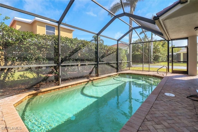 view of swimming pool with a lanai and a patio area