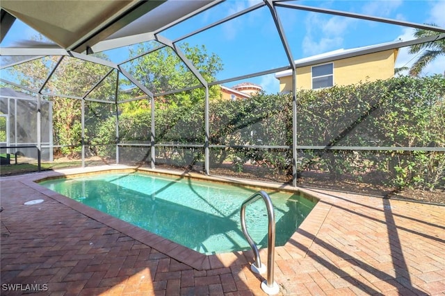 view of swimming pool with a lanai and a patio area