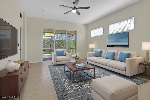 tiled living room with a wealth of natural light and ceiling fan