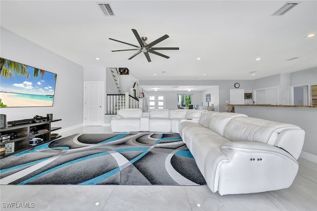living area featuring visible vents, recessed lighting, stairway, and baseboards