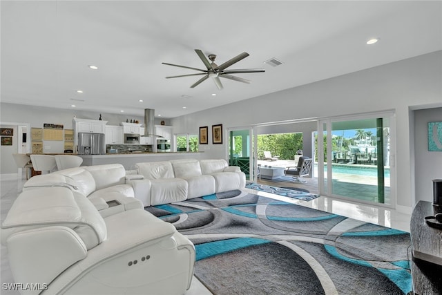 living area featuring recessed lighting, visible vents, and ceiling fan