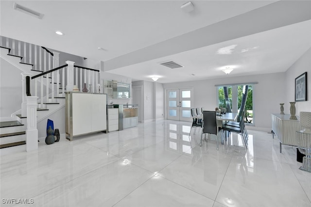 interior space with stairs, french doors, visible vents, and baseboards