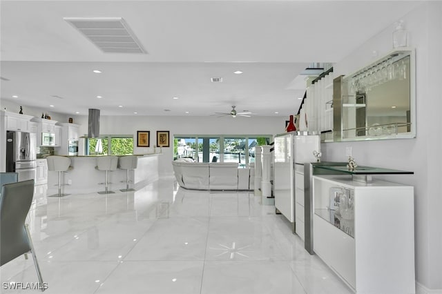hall featuring recessed lighting, visible vents, and marble finish floor