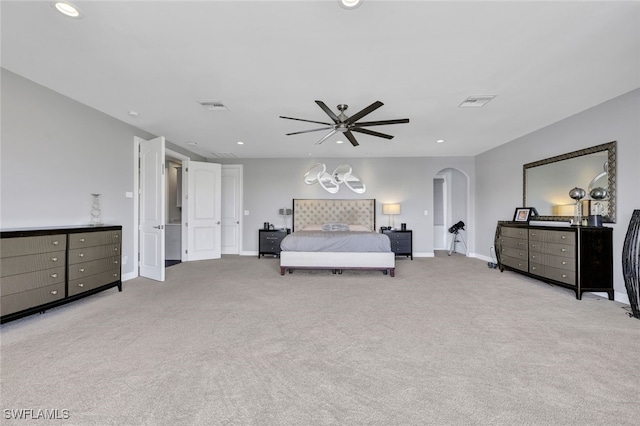 carpeted bedroom with arched walkways, visible vents, recessed lighting, and baseboards