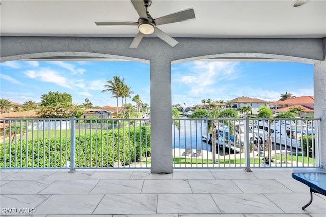 view of patio with a balcony, a ceiling fan, and a residential view