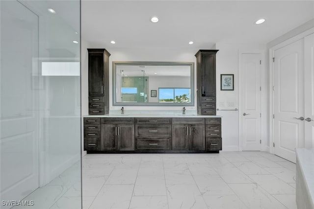full bathroom with recessed lighting, marble finish floor, and a sink