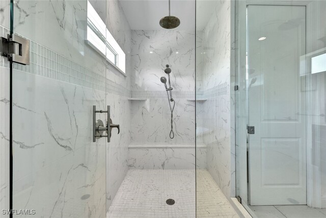full bath with a marble finish shower