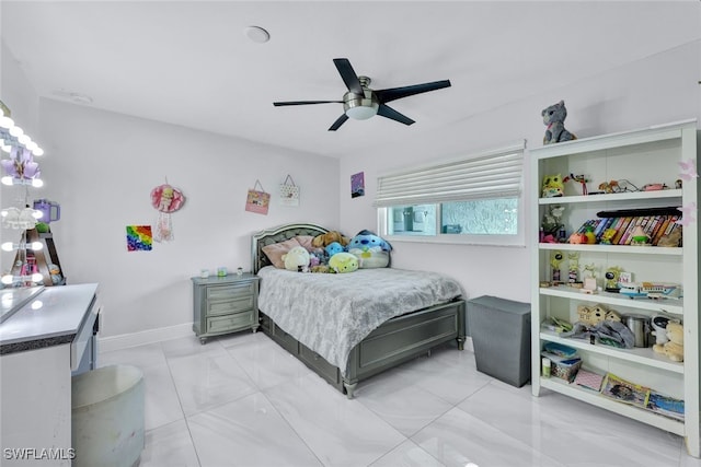 bedroom with light tile patterned floors, baseboards, and a ceiling fan