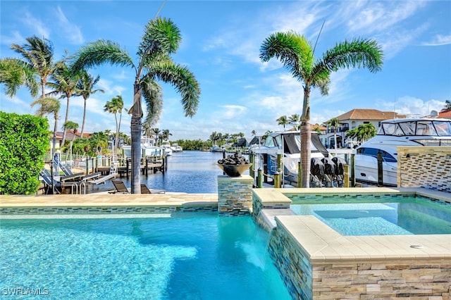 view of pool with a water view, boat lift, a boat dock, and a pool with connected hot tub