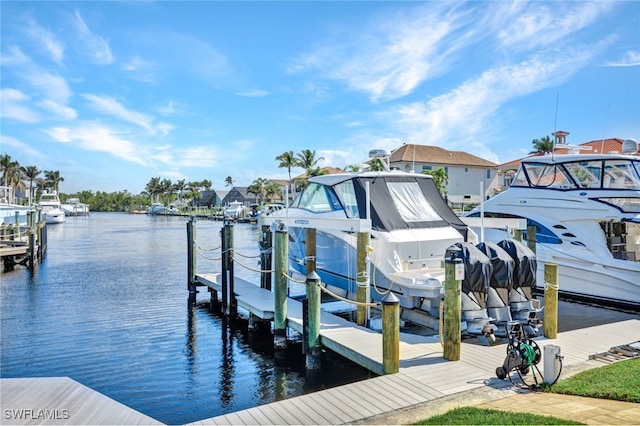 view of dock with boat lift and a water view