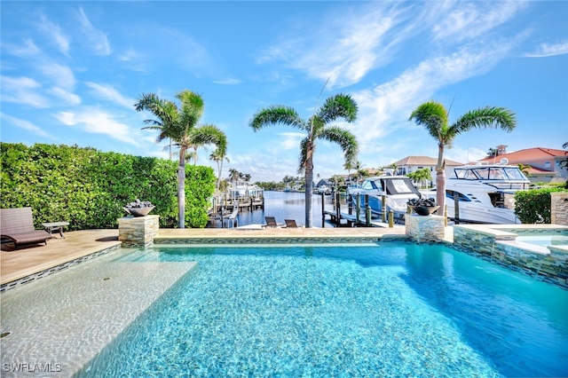 view of swimming pool with a water view and a dock