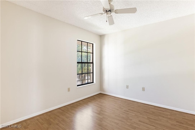 spare room with ceiling fan, hardwood / wood-style floors, and a textured ceiling