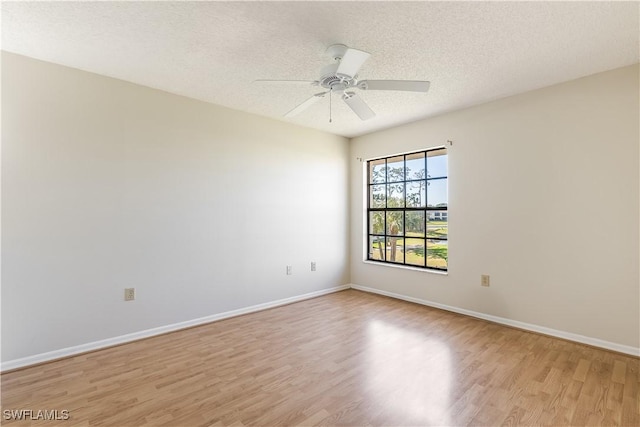 unfurnished room with ceiling fan, light hardwood / wood-style floors, and a textured ceiling