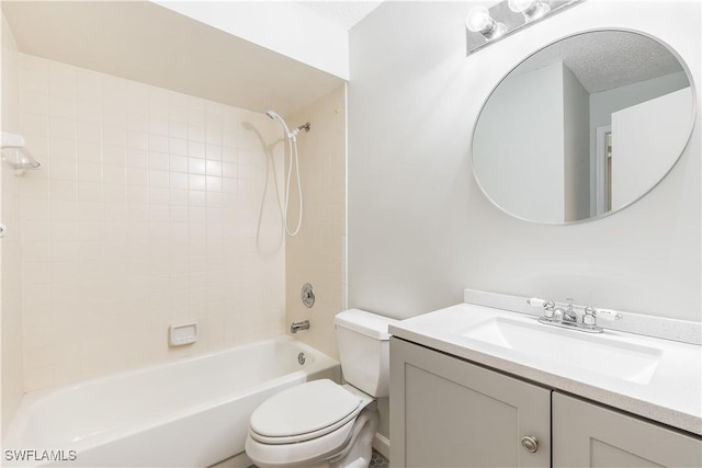 full bathroom featuring vanity, tiled shower / bath combo, and toilet