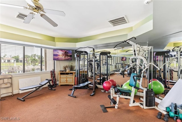 gym with ceiling fan and carpet