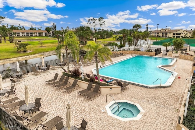 view of swimming pool featuring a community hot tub and a patio