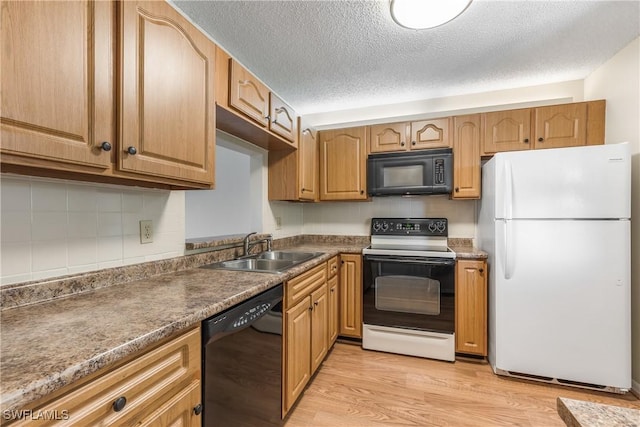 kitchen with sink, light hardwood / wood-style flooring, a textured ceiling, and black appliances