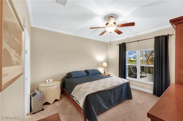 carpeted bedroom featuring crown molding and ceiling fan