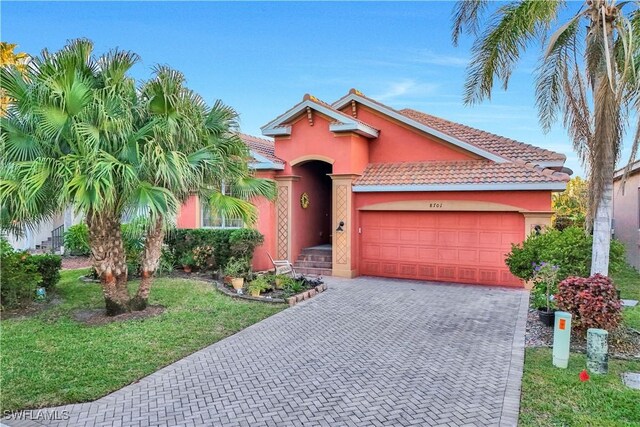 view of front of property featuring a garage and a front yard