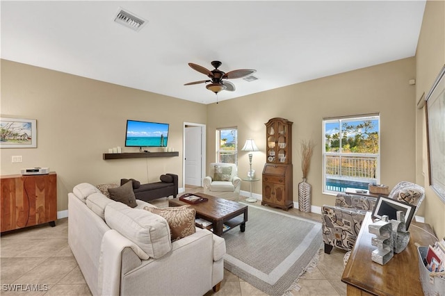 living room with ceiling fan and light tile patterned floors