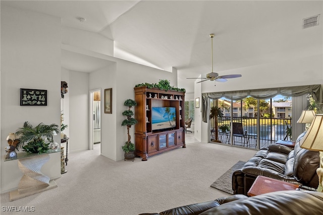 living room with lofted ceiling, light colored carpet, and ceiling fan