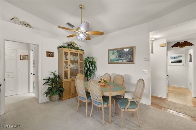 carpeted dining area featuring ceiling fan