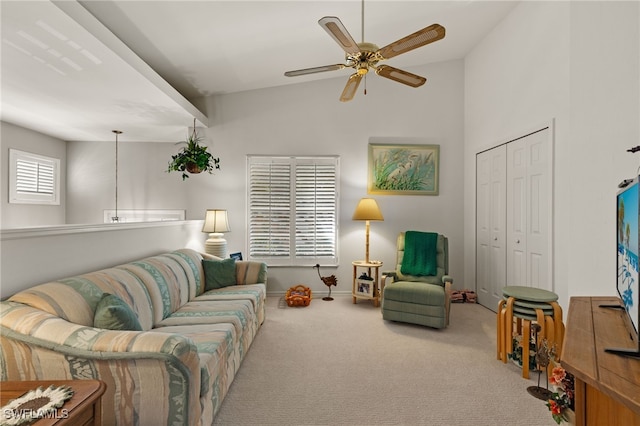 living room with ceiling fan, lofted ceiling, and light carpet