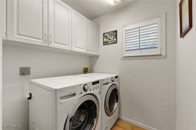 laundry area with cabinets and washer and clothes dryer