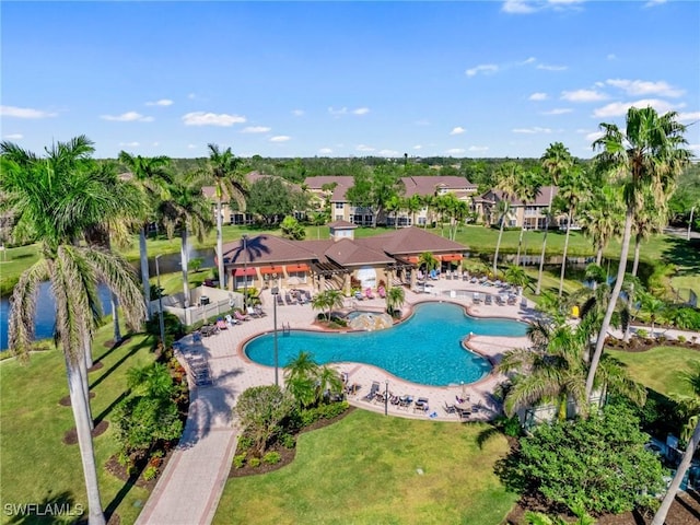 view of swimming pool featuring a yard and a patio area