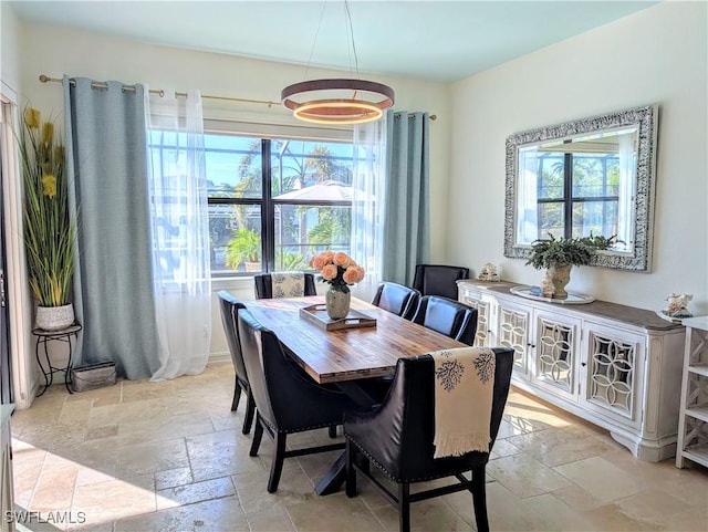 dining room featuring stone tile floors