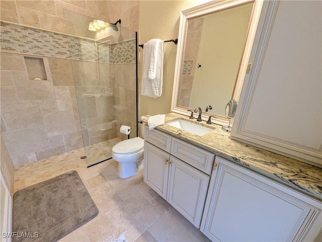 bathroom featuring toilet, a walk in shower, and vanity