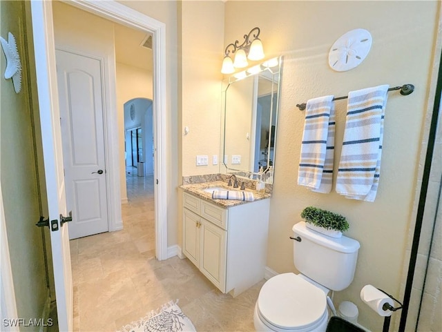 bathroom featuring toilet and vanity