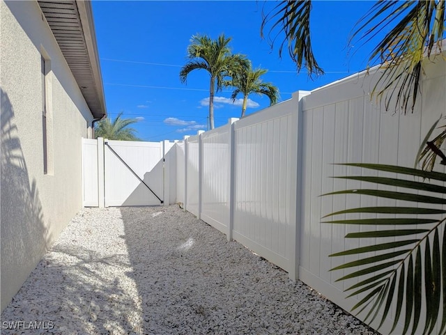 view of yard with a gate and a fenced backyard