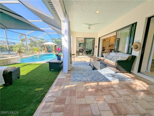 view of patio / terrace featuring an outdoor pool, outdoor lounge area, and a ceiling fan