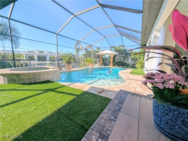 view of pool featuring glass enclosure, a patio, a pool with connected hot tub, and a lawn