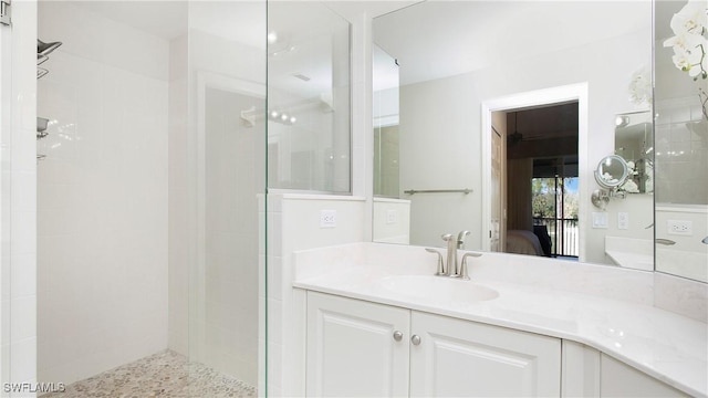 bathroom with vanity and a tile shower