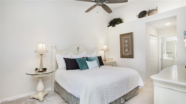 carpeted bedroom featuring connected bathroom, a closet, and ceiling fan