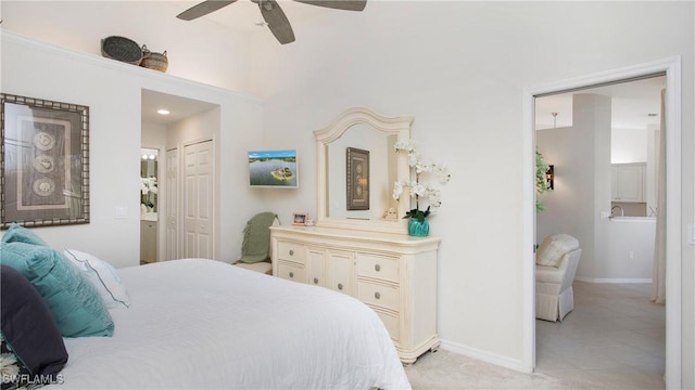 bedroom with a closet, ceiling fan, and ensuite bathroom