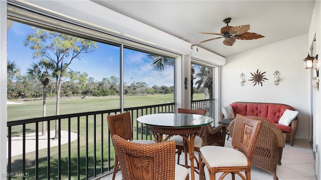 sunroom / solarium featuring ceiling fan