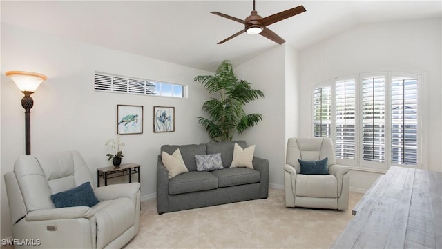 carpeted living room with ceiling fan and vaulted ceiling