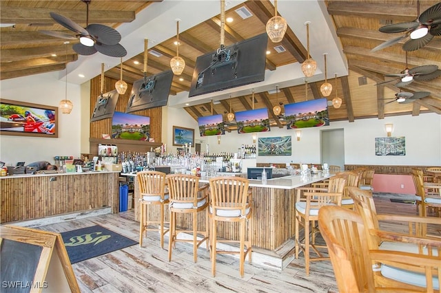 kitchen with wood ceiling, a breakfast bar, kitchen peninsula, and light wood-type flooring