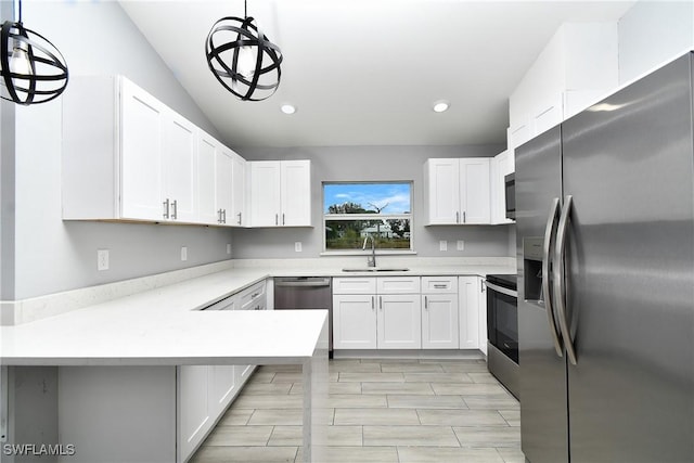 kitchen featuring pendant lighting, white cabinetry, sink, kitchen peninsula, and stainless steel appliances