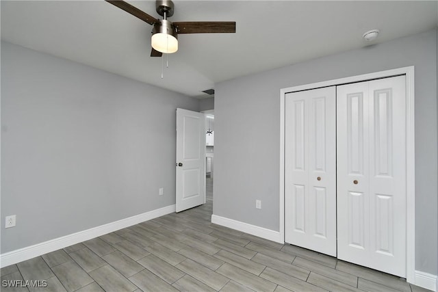 unfurnished bedroom with ceiling fan, a closet, and light wood-type flooring